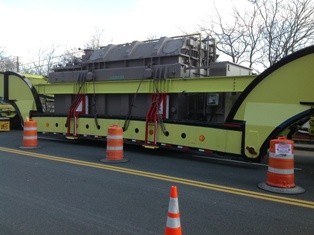 Steadman Parking Services officer managing an oversized crane component transport on a New York road