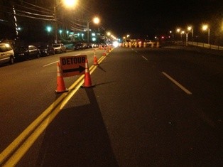 Overnight traffic control with reflective cones on a double-yellow line road